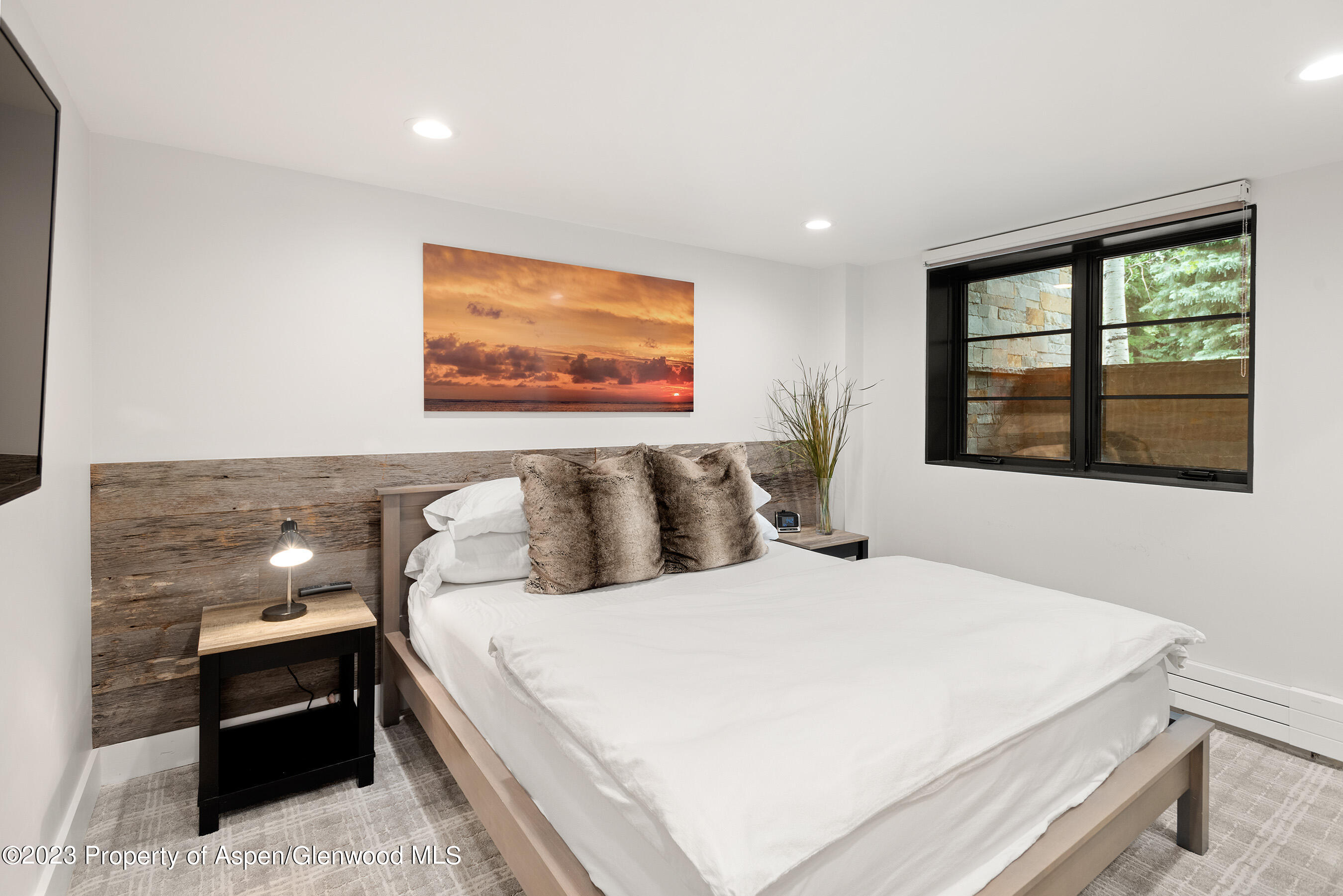 503 North 4th Street Aspen, CO 81611 - Photo 14 of 21 a large bed sitting in a bedroom next to a window