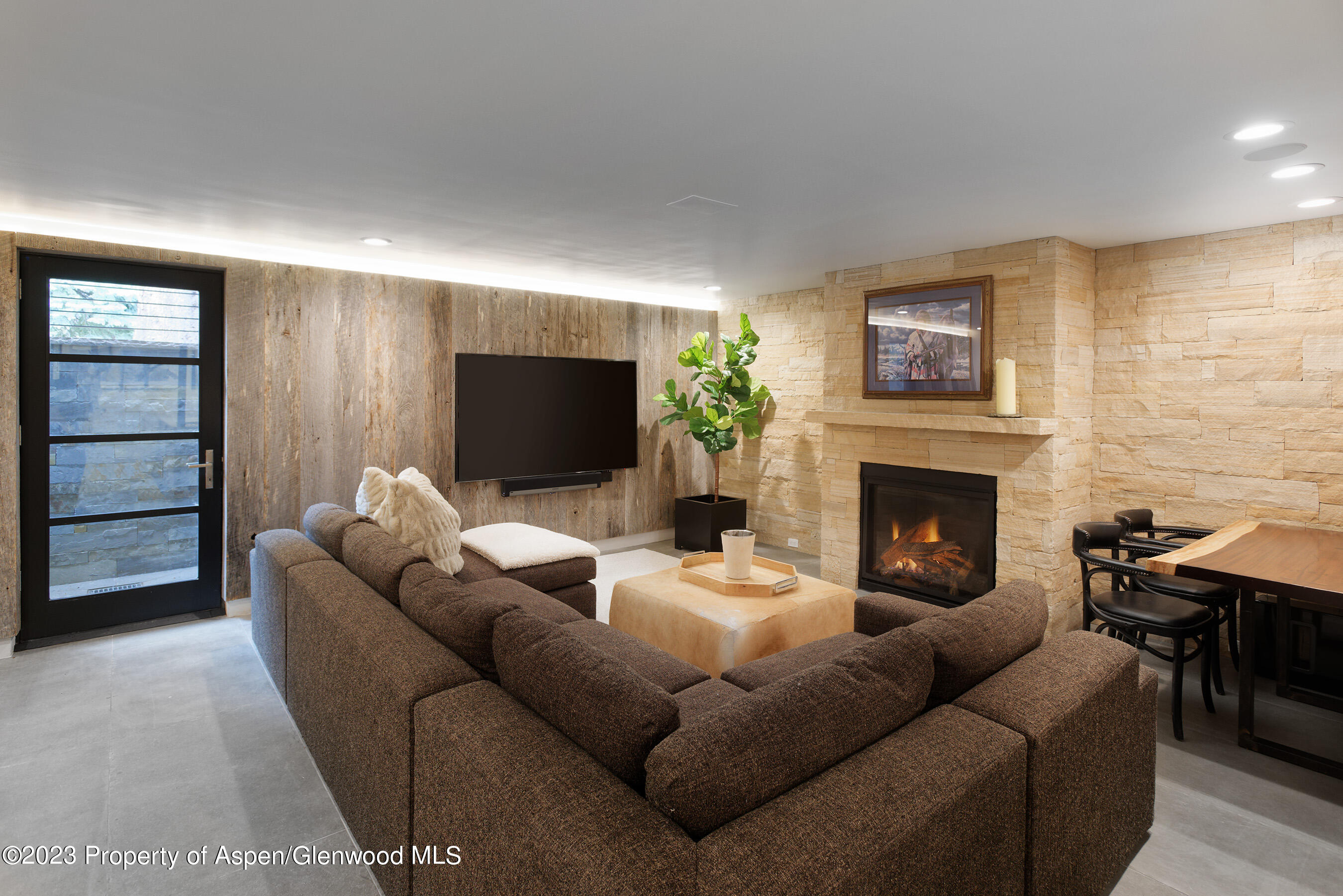 503 North 4th Street Aspen, CO 81611 - Photo 18 of 21 a living room with furniture a flat screen tv and a fireplace