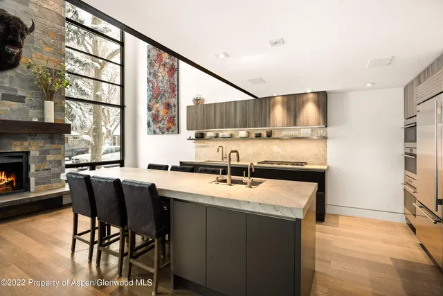 a kitchen with stainless steel appliances granite countertop a sink and a refrigerator