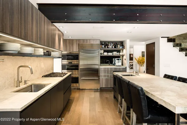a kitchen with stainless steel appliances granite countertop a sink counter space and cabinets