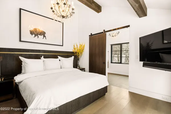 a large bed sitting in a bedroom next to a window