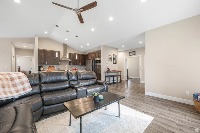 4527 North Seven Bridges Road Eden, UT 84310 - Photo 13 of 65 Living room featuring a ceiling fan, light wood-style flooring, recessed lighting, and vaulted ceiling