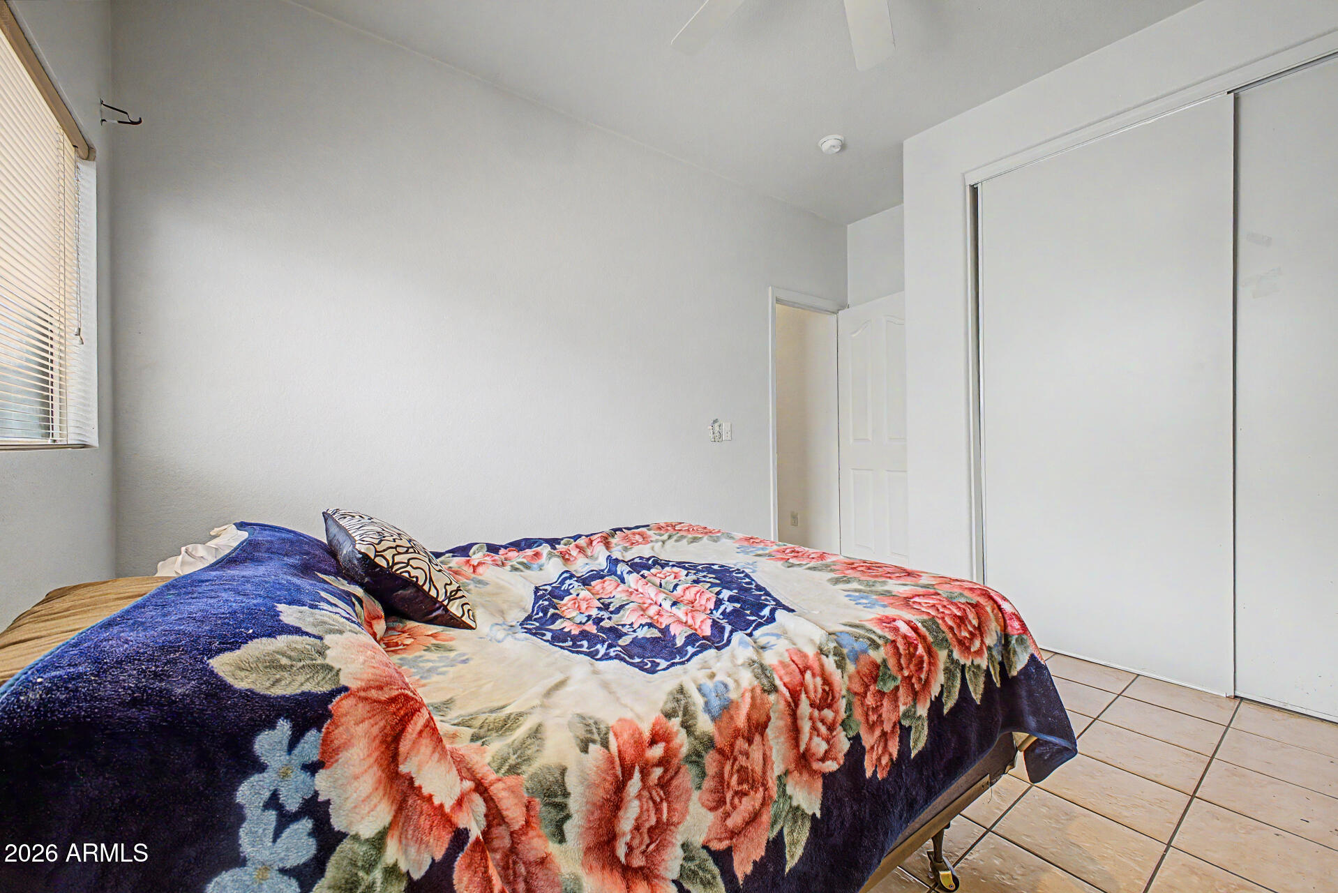 9730 West Payson Road Tolleson, AZ 85353 - Photo 23 of 57 a bedroom with a bed and a window