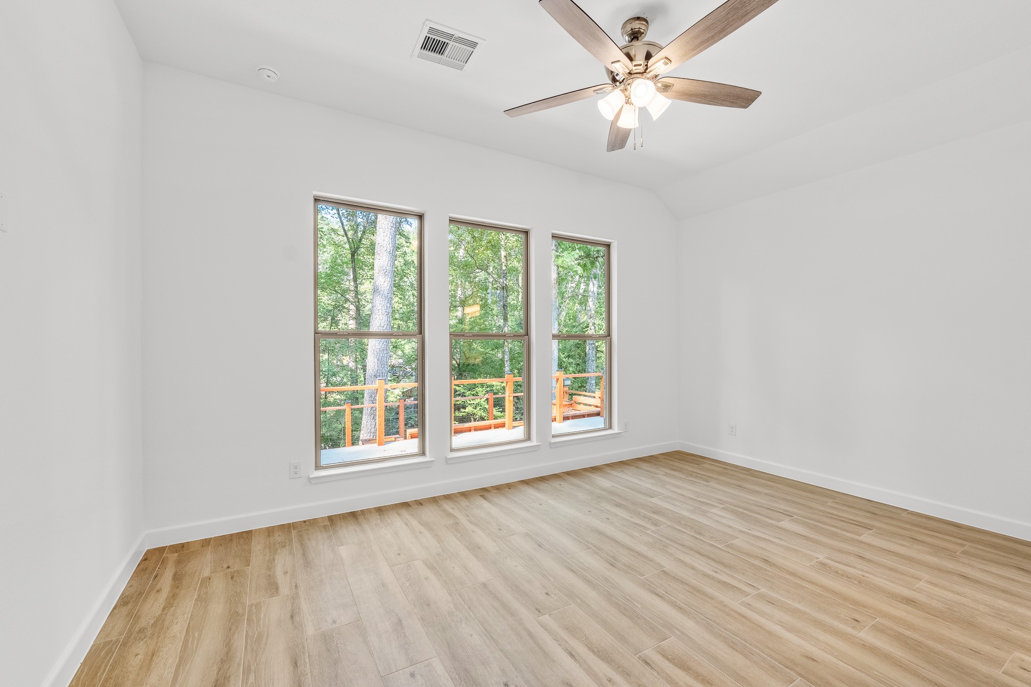 205 Tall Pine Livingston, TX 77351 - Photo 13 of 42 wooden floor in an empty room with a window