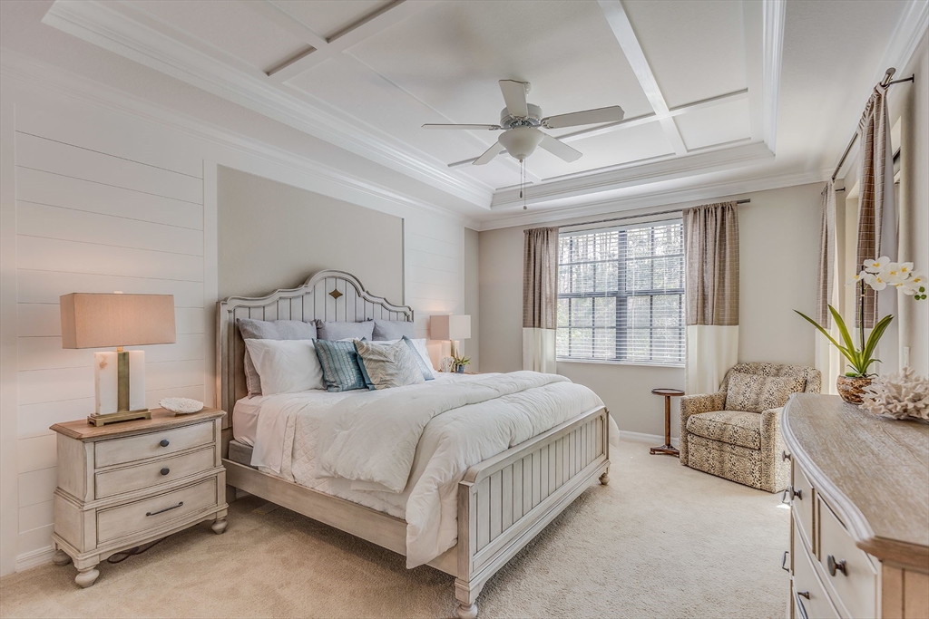 15 Mallard Lane, Unit 7 Walpole, MA 02081 - Photo 6 of 7 a bedroom with a bed and a chandelier