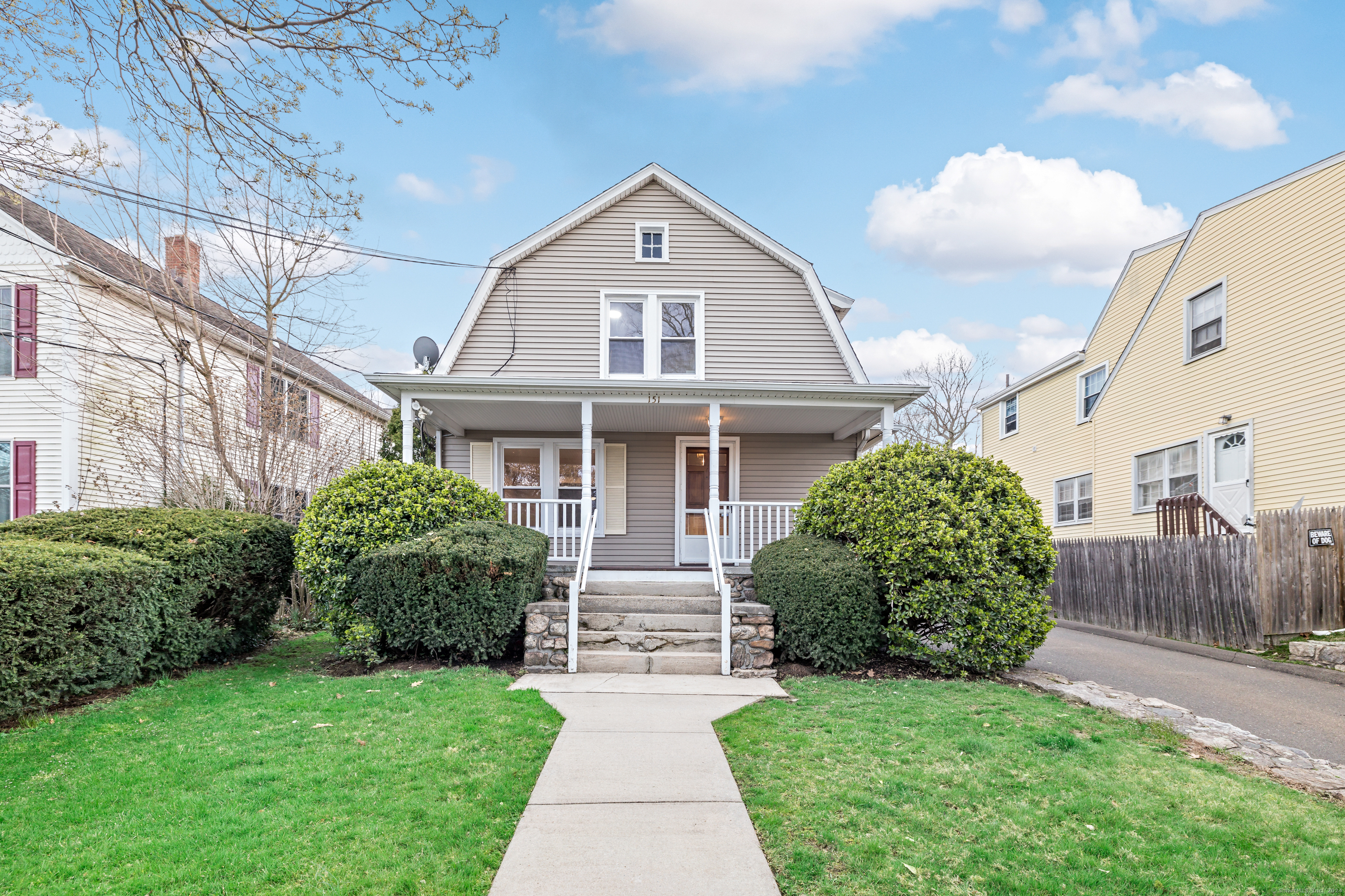 151 Seaside Avenue, Unit 4 Stamford, CT 06902 - Photo 1 of 1 a front view of a house with a garden