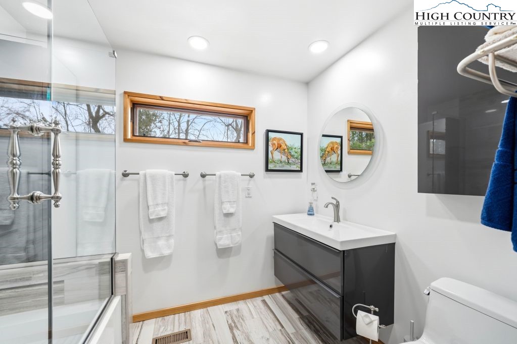 408 Eagle Ridge Road Roan Mountain, TN 37687 - Photo 19 of 45 a bathroom with a sink and a mirror