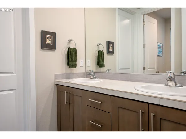 a bathroom with a double vanity sink and a mirror