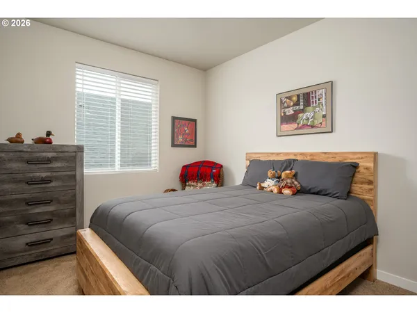 a bedroom with a bed and a dresser