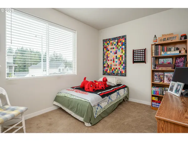 a bedroom with a bed and a book shelf