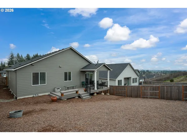 a view of a house with wooden fence