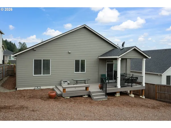 a backyard of a house with table and chairs