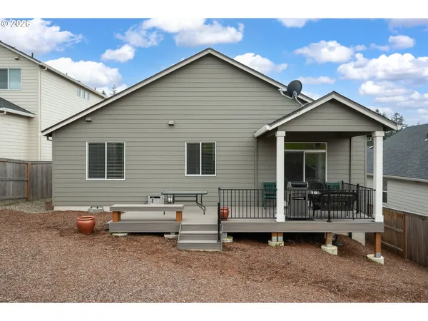 a backyard of a house with table and chairs