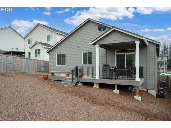 a view of a house with a yard and sitting area
