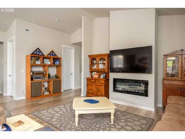 a living room with furniture a flat screen tv and a fireplace