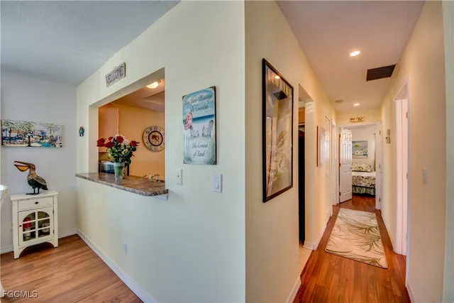 a view of a hallway with wooden floor and closet