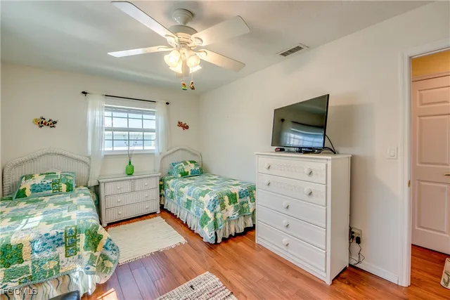 a bedroom with furniture and a flat screen tv