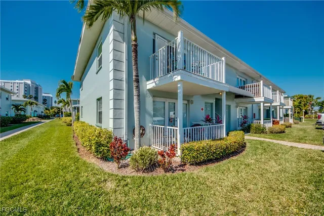 a view of a house with a yard table and chair