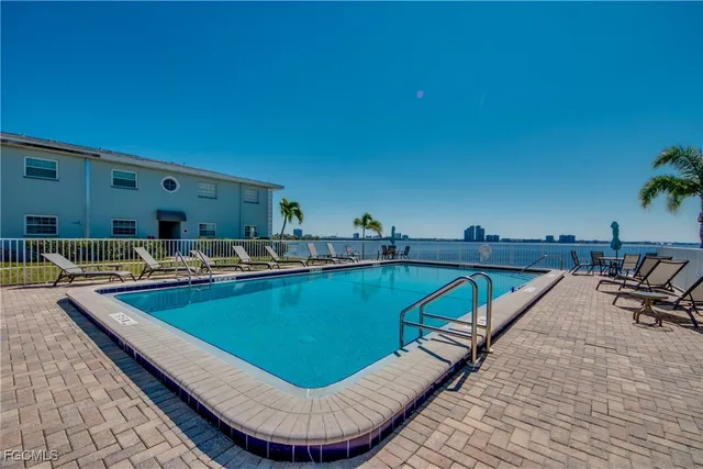 a view of swimming pool with chairs