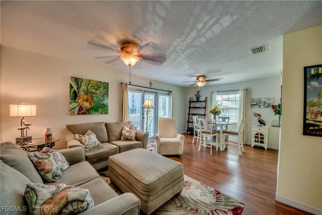 a living room with furniture and a wooden floor