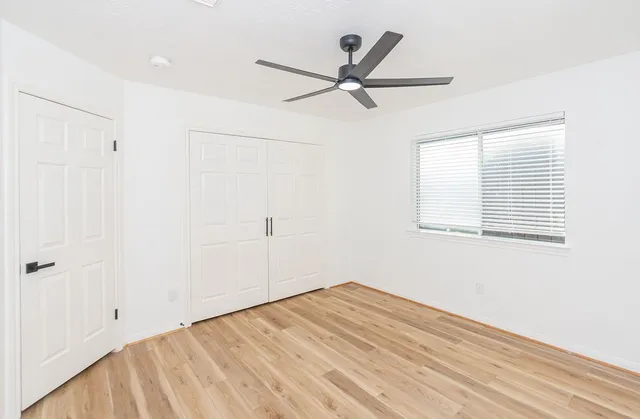a view of a room with a window and a ceiling fan