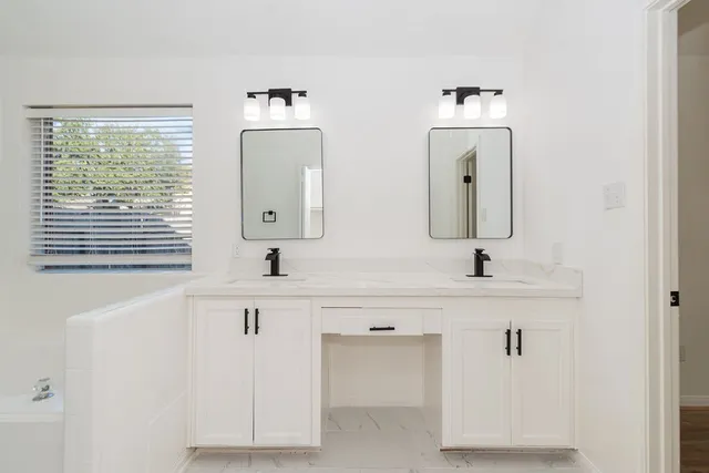 a bathroom with a sink vanity and a mirror
