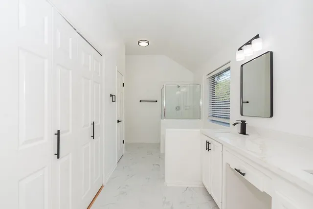 a bathroom with a double vanity sink mirror and