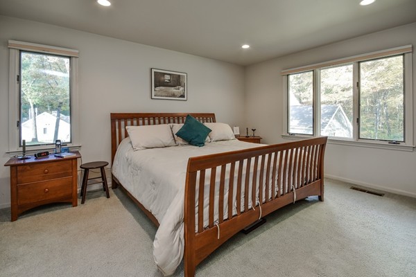 7 Steepletree Lane, Unit 7 Wayland, MA 01778 - Photo 12 of 22 a bed sitting in a bedroom next to a window