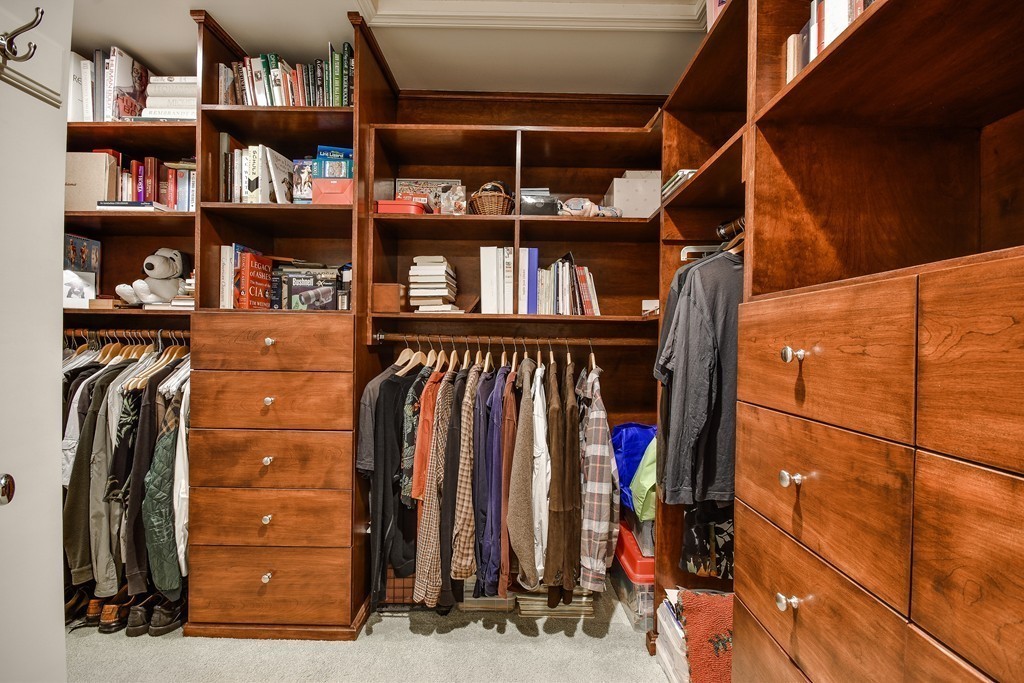 7 Steepletree Lane, Unit 7 Wayland, MA 01778 - Photo 13 of 22 a view of walk in closet with clothes and shoes