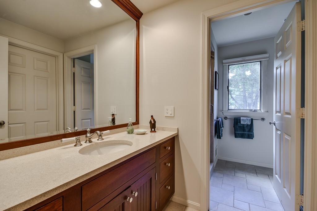 7 Steepletree Lane, Unit 7 Wayland, MA 01778 - Photo 14 of 22 a bathroom with a sink and a mirror