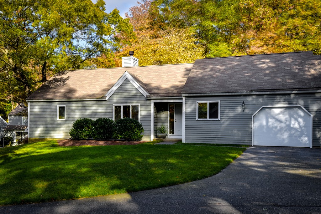 7 Steepletree Lane, Unit 7 Wayland, MA 01778 - Photo 2 of 22 a front view of a house with a garden and yard