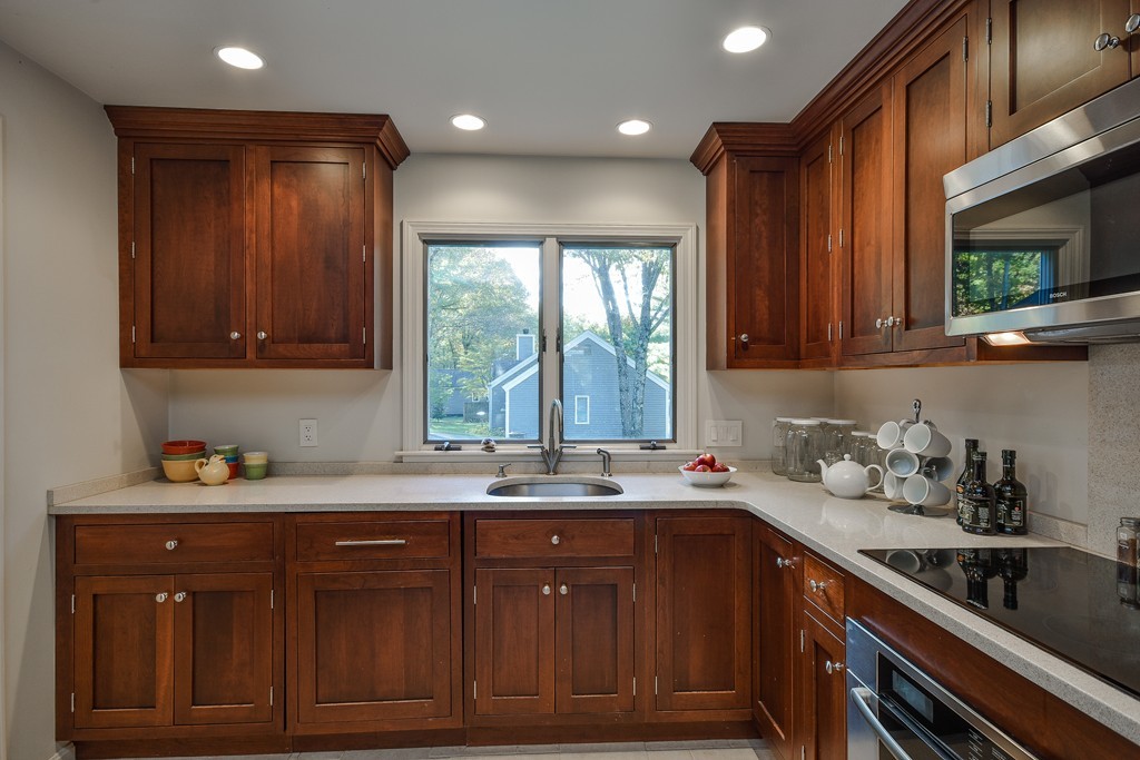 7 Steepletree Lane, Unit 7 Wayland, MA 01778 - Photo 5 of 22 a kitchen with a sink a window and cabinets