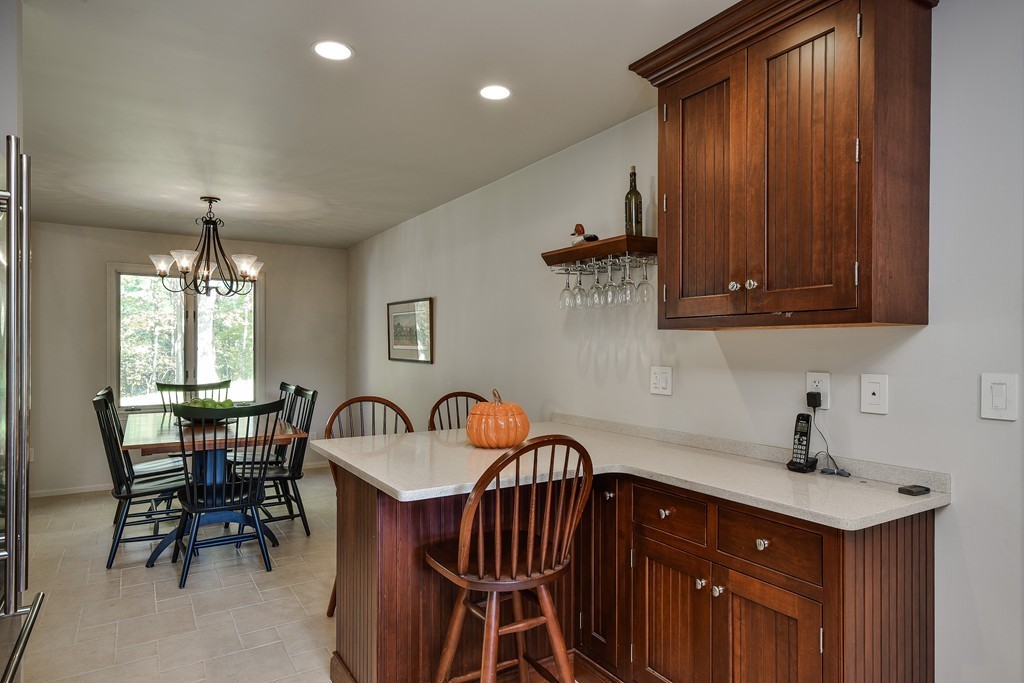 7 Steepletree Lane, Unit 7 Wayland, MA 01778 - Photo 6 of 22 a kitchen with a sink a cabinets and chairs
