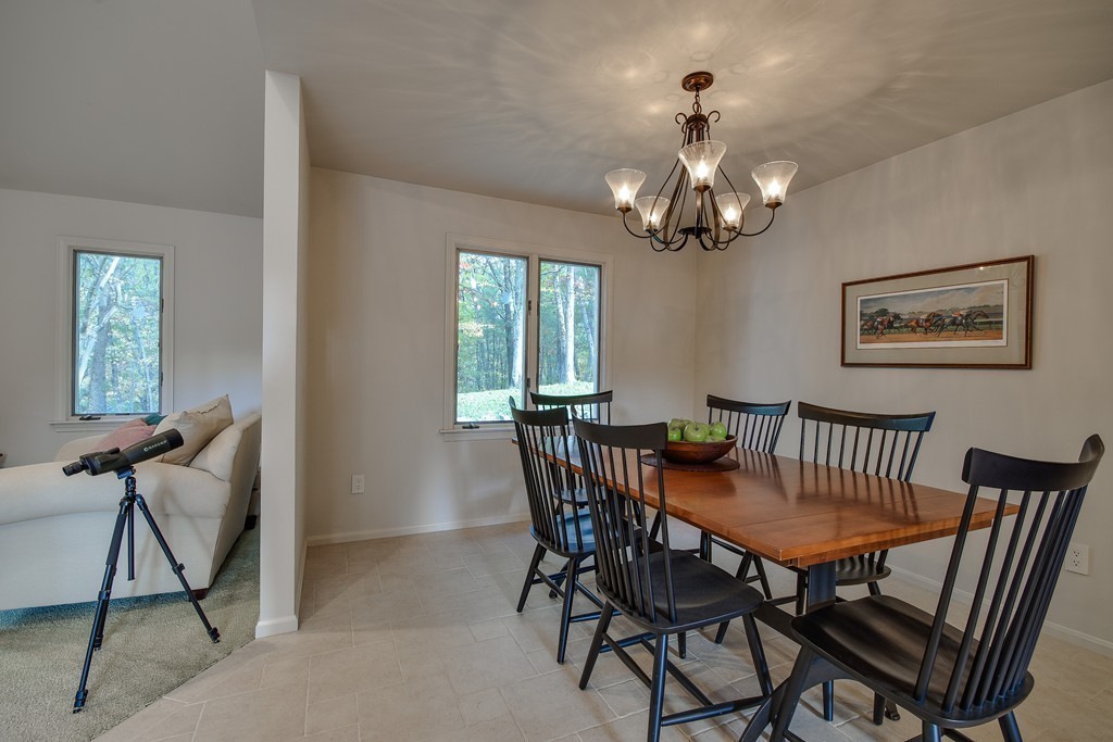 7 Steepletree Lane, Unit 7 Wayland, MA 01778 - Photo 7 of 22 a view of a dining room with furniture and a chandelier