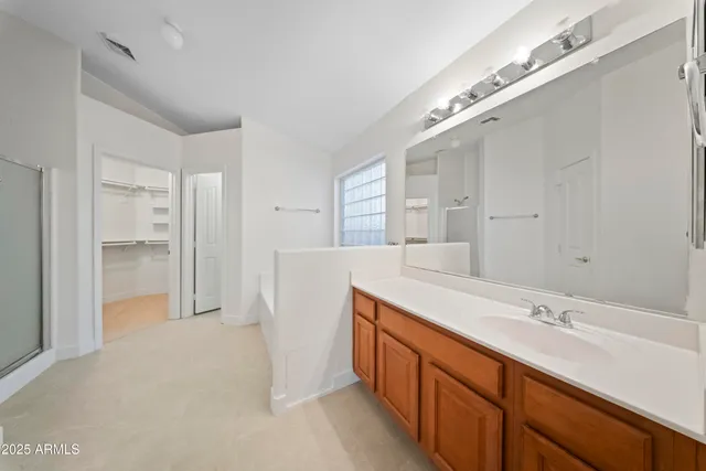 a spacious bathroom with a double vanity sink and a mirror