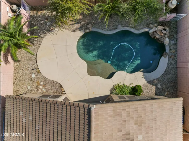 an aerial view of a house with a yard and large trees
