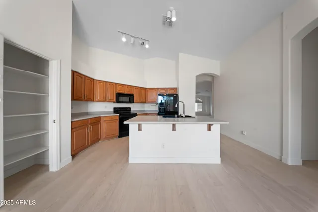 a view of kitchen with cabinets and wooden floor