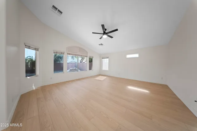 a view of a livingroom with furniture ceiling fan and wooden floor