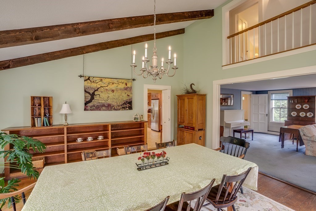 35 Wilson Road Bedford, MA 01730 - Photo 11 of 42 a view of a dining room with furniture a chandelier and wooden floor