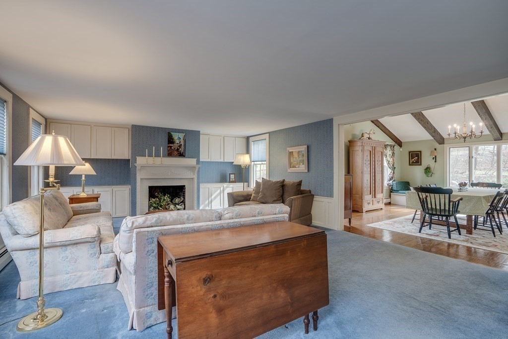 35 Wilson Road Bedford, MA 01730 - Photo 12 of 42 a living room with furniture a fireplace and a table