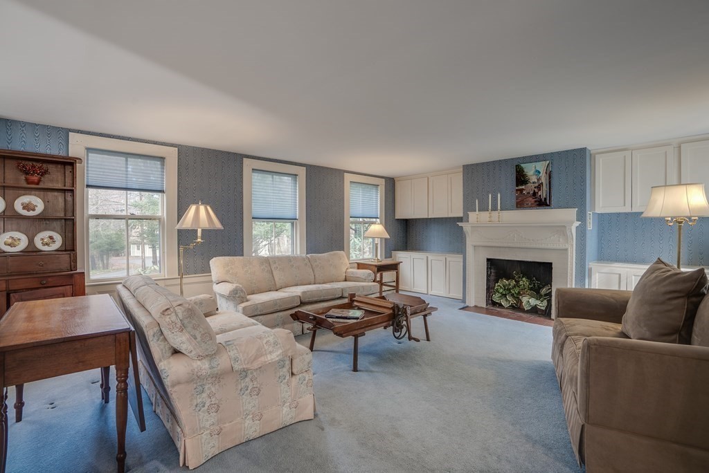 35 Wilson Road Bedford, MA 01730 - Photo 13 of 42 a living room with furniture and a fireplace