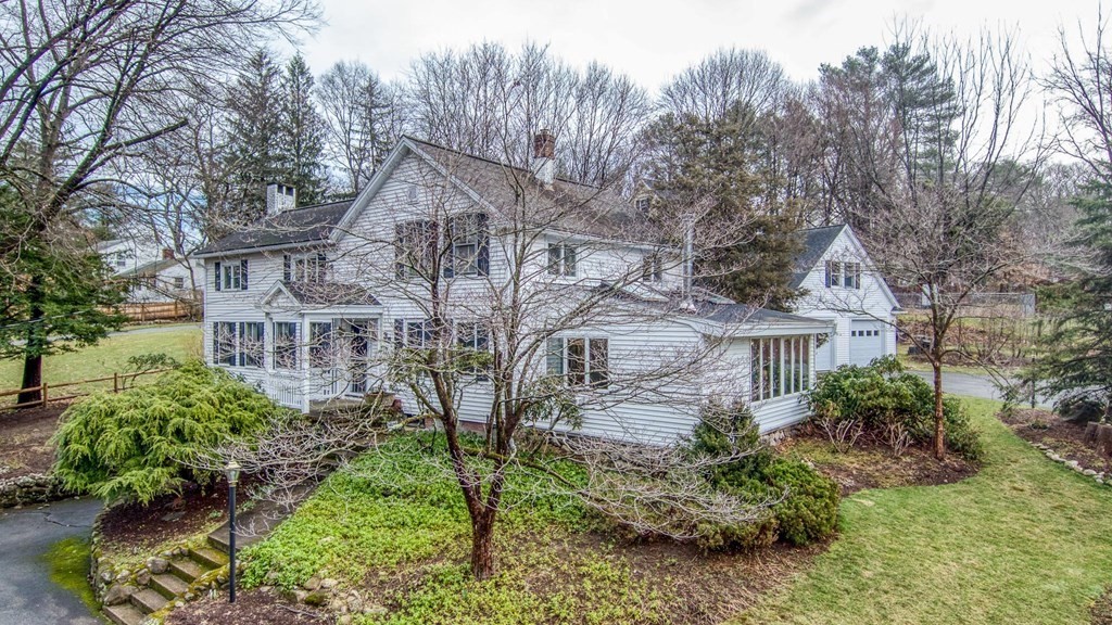 35 Wilson Road Bedford, MA 01730 - Photo 2 of 42 a view of a house with a yard and plants