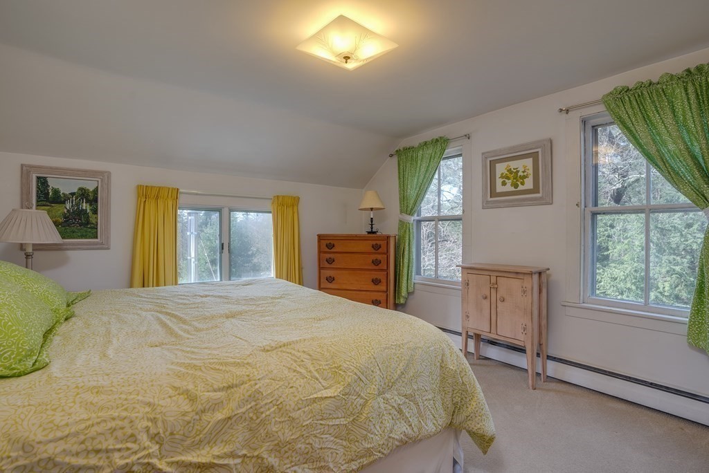 35 Wilson Road Bedford, MA 01730 - Photo 25 of 42 a bedroom with a bed and a dresser next to a window