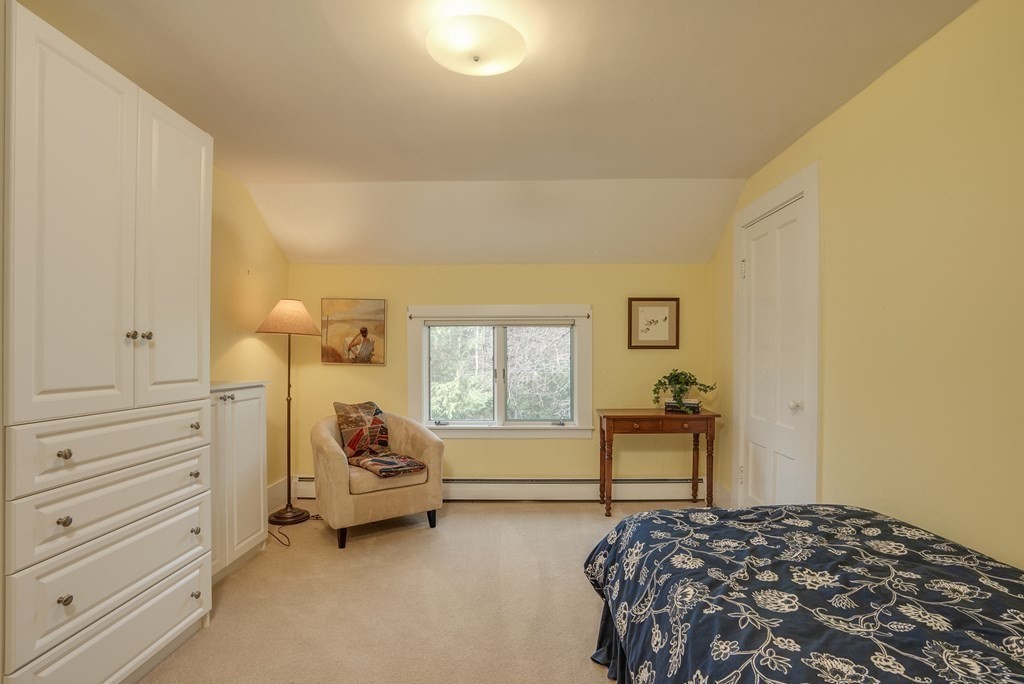 35 Wilson Road Bedford, MA 01730 - Photo 27 of 42 a bedroom with a bed and wooden floor
