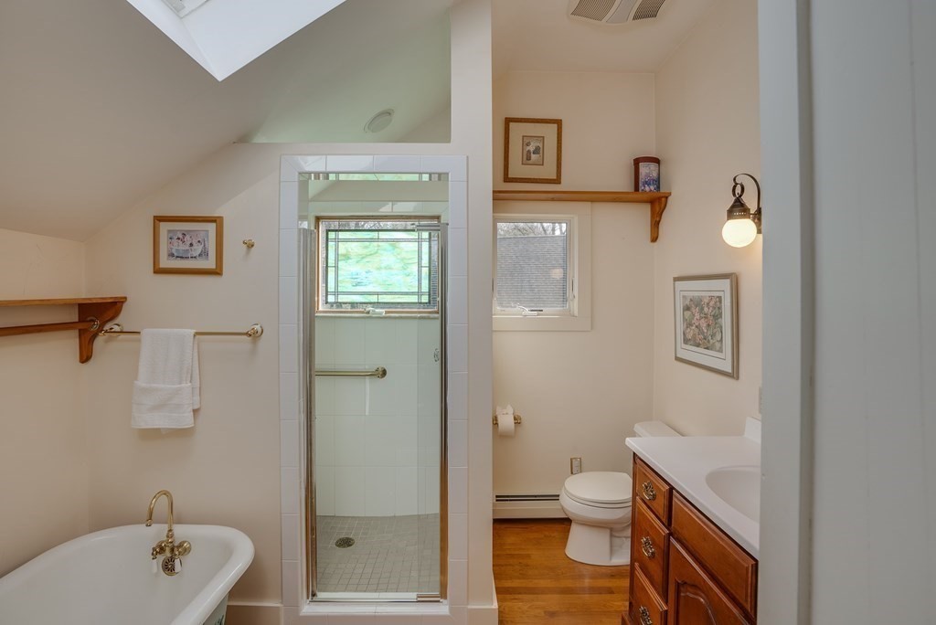 35 Wilson Road Bedford, MA 01730 - Photo 31 of 42 a bathroom with a granite countertop toilet a sink and a mirror