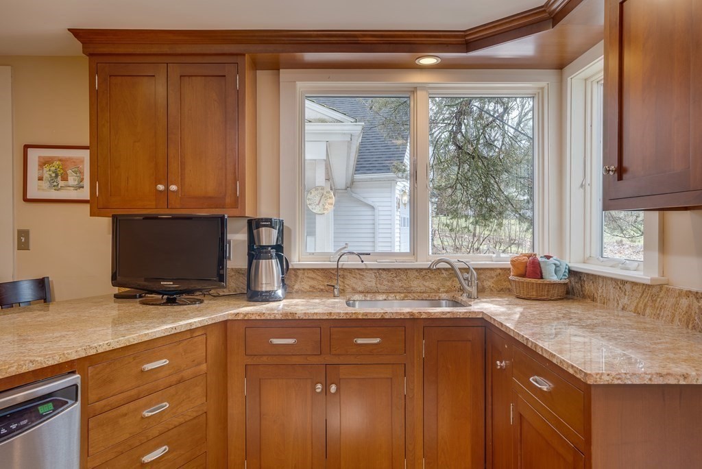 35 Wilson Road Bedford, MA 01730 - Photo 4 of 42 a kitchen with granite countertop a sink a stove a counter space and cabinets