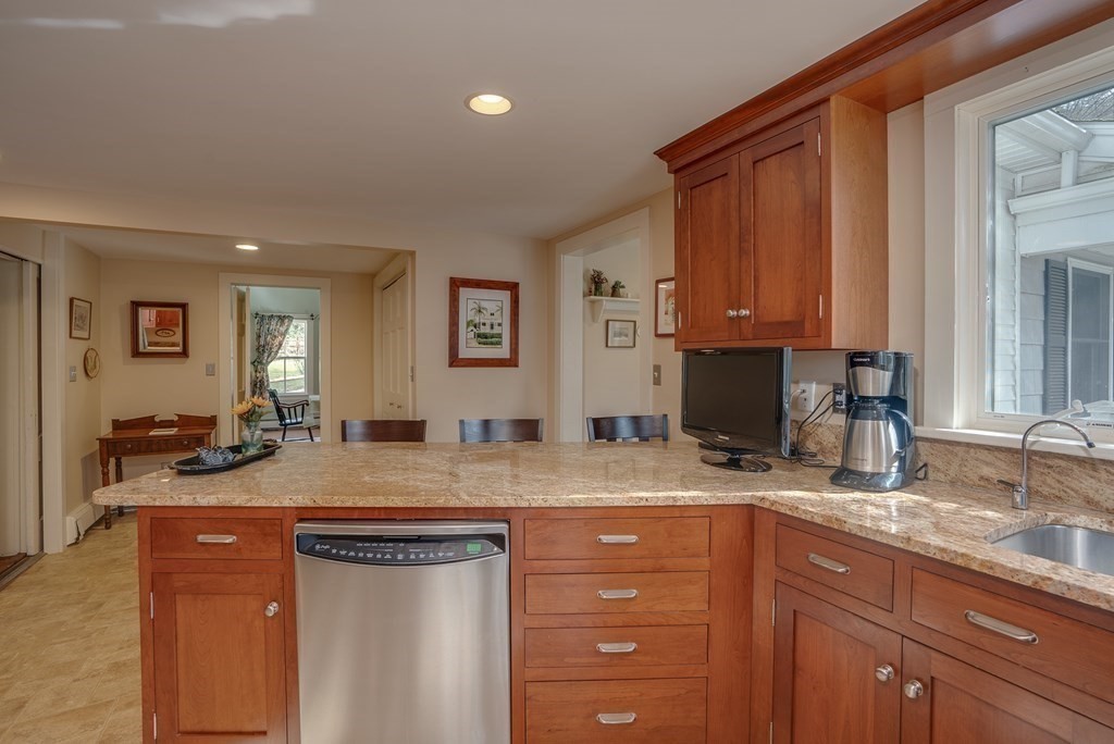 35 Wilson Road Bedford, MA 01730 - Photo 5 of 42 a kitchen with stainless steel appliances granite countertop a sink a stove and cabinets