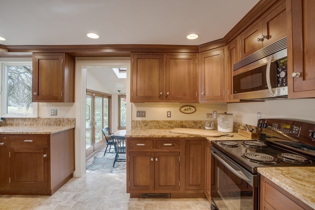 35 Wilson Road Bedford, MA 01730 - Photo 6 of 42 a kitchen with stainless steel appliances granite countertop a stove a sink and a microwave