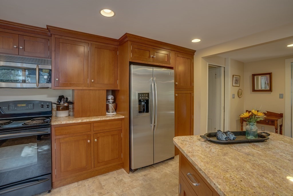 35 Wilson Road Bedford, MA 01730 - Photo 7 of 42 a kitchen with a refrigerator and a stove top oven