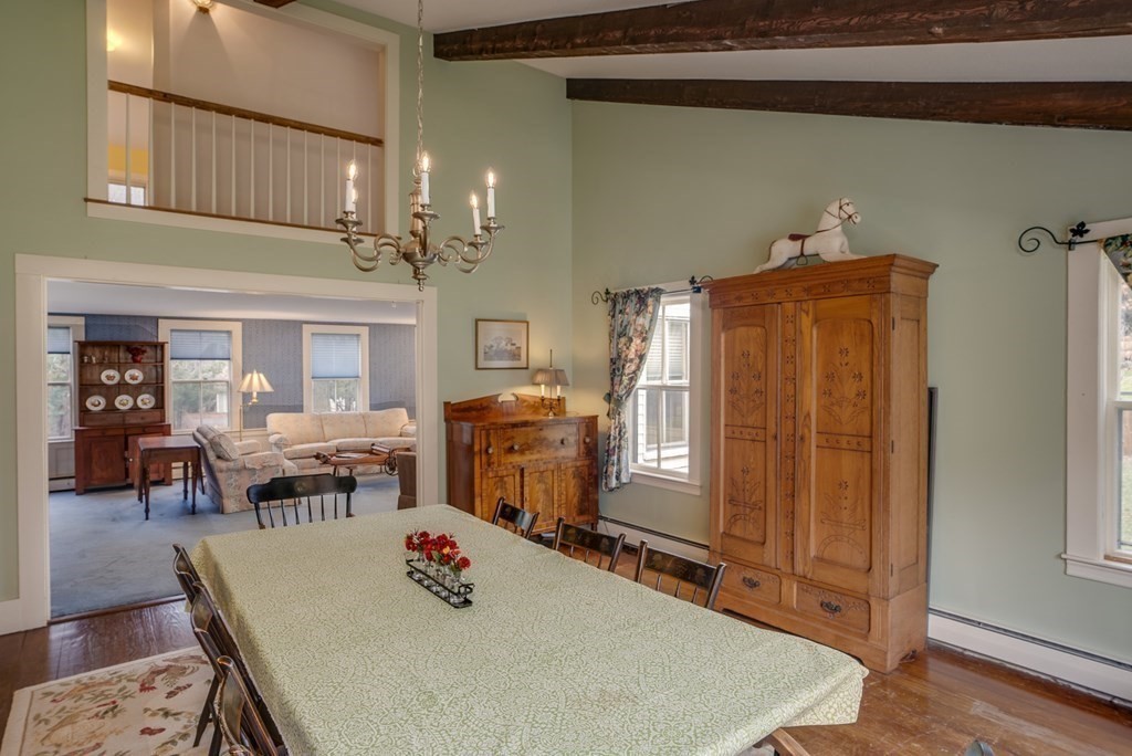 35 Wilson Road Bedford, MA 01730 - Photo 9 of 42 a dining room with furniture a rug and wooden floor